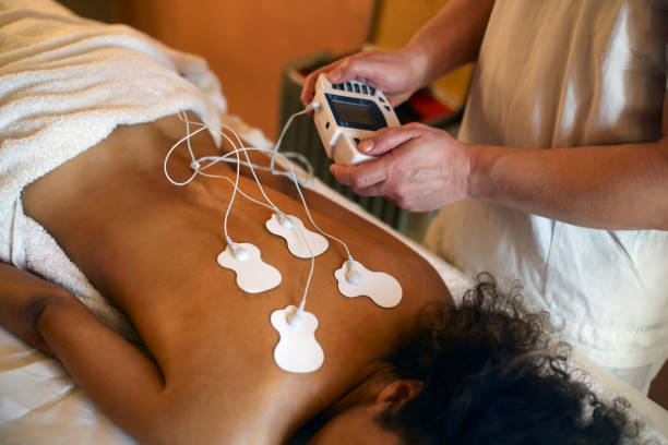 Young woman during an electrical stimulation therapy. About 25 years old, Mixed race female.