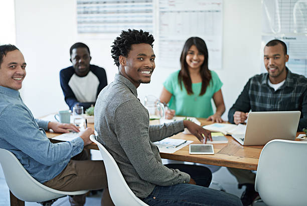 Portrait of young businesspeople sitting in a boardroom http://195.154.178.81/DATA/istock_collage/0/shoots/784885.jpg