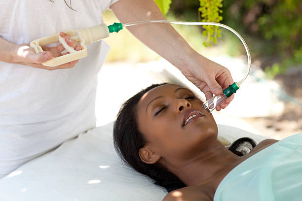 Healthcare practitioner using vacuum gun for cupping therapy (traditional Chinese medicine).