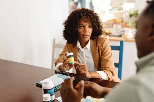 Female nutritionist advising patient on vitamin intake during consultation