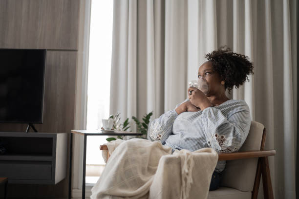 Mature woman using an inhalation mask at home