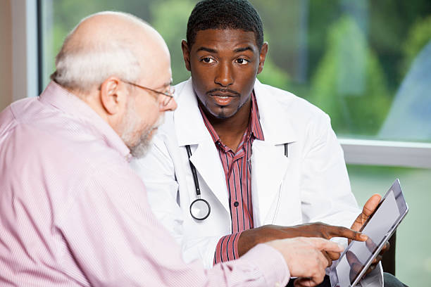 Doctor explaining treatment to a senior man on digital tablet. You might also be interested in these: