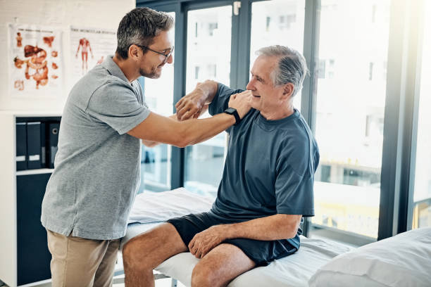 Shot of a skilled physiotherapist testing his mature patient's mobility in the rehabilitation center